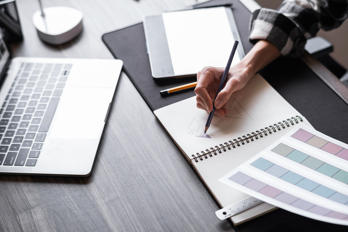 Graphic designer working with sketching logo design at office.